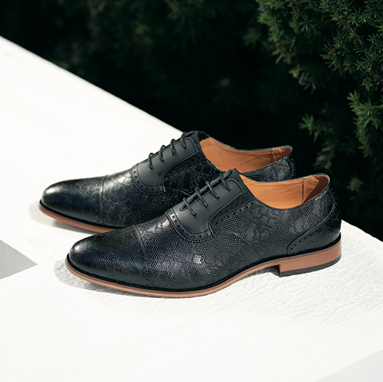 "Why Men’s Black Shoes Are A Wardrobe Must-Have." The featured product is the Stratton Cap Toe Oxford in Black.