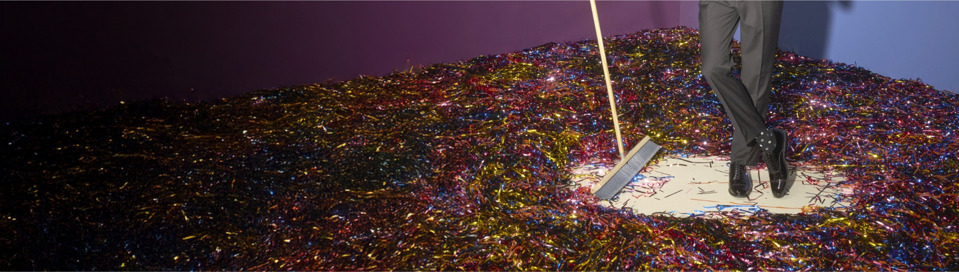 Shop our end of season clearance featuring a man sweeping up tinsel.