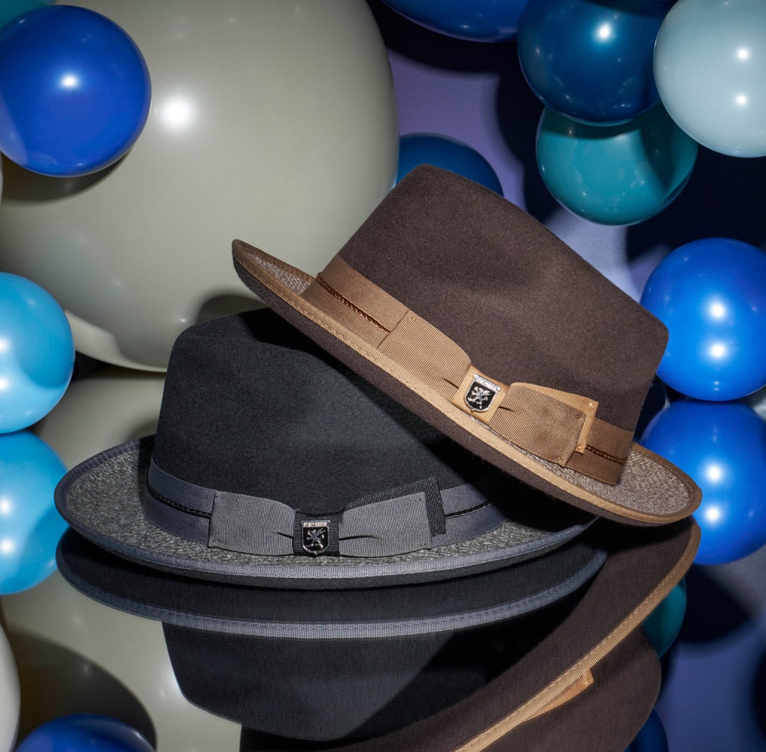 Shop Stacy Adams hats featuring the Zaylen fedora on a mirrored floor. 