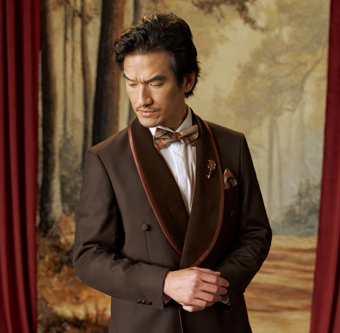 Shop Stacy Adams Brown Edit featuring the Spratley suit in Brown on a man posing with a portrait of a landscape behind him.