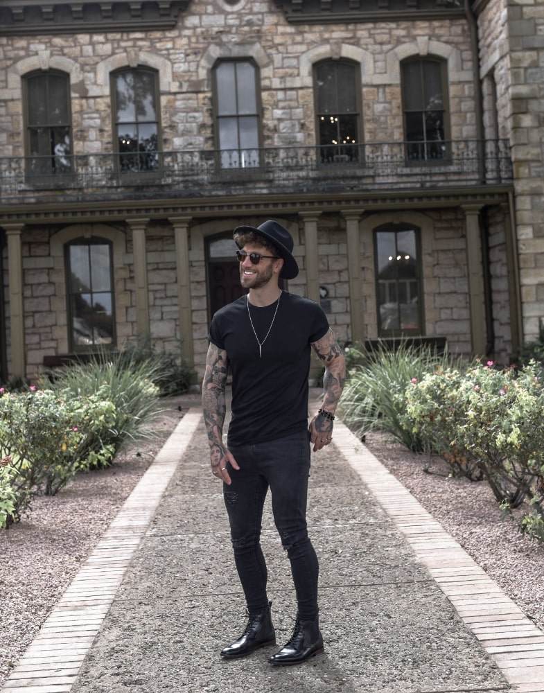 Image of social media influencer Eddy Grim wearing the Rupert Plain Toe Lace and Gore Boot in Black while posing for a picture.