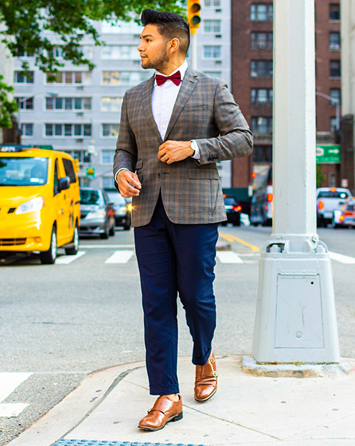 Image of social media influencer Diego Leon wearing the Madison Cap Toe Double Monk Strap in Oak while crossing the street.