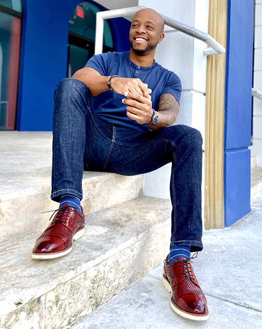 Image of social media influencer Kenny Daniels wearing the Ellery Cap Toe Oxford in Red outside in Miami, Florida.