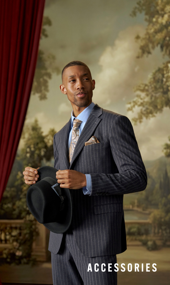 Dress Shirts category. Image features a man in a pinstripe grey suit with a blue shirt and holding a wool fedora. 