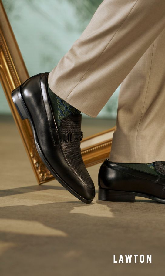 Men's Dress Shoes category. Image features the Lawton Moc Toe Bit Slip On in Black with a picture frame behind the shoes.