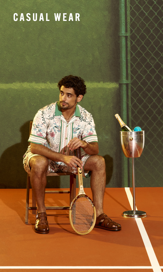 Men's Casual Wear category. Image features a man sitting courtside on a pickleball court.