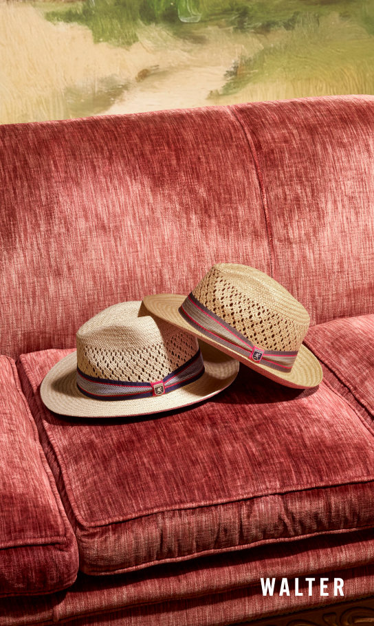 Men's Hats category. Image features the Walter fedora in 2 colors on a red sofa.