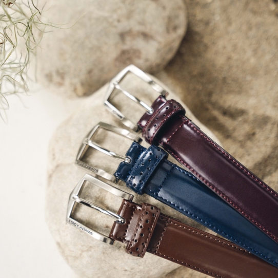 "Men’s Belts: The Perfect Finishing Touch." The featured image is the Pinseal Perf Strap Genuine Leather Belt in Cordovan, Navy, and Chocolate.