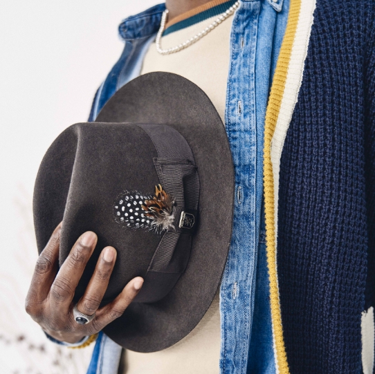 "Men’s Accessories that Complete your Look." The featured image is a model holding the Clifton Fedora hat in Charcoal.