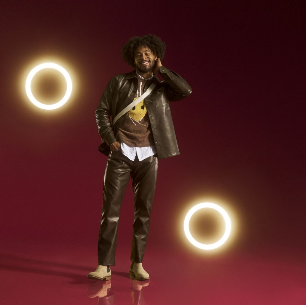 "Finding Men's Fashion Advice Using Social Media." The featured image is a model wearing a light-colored pair of Stacy Adams suede boots on a red background. 