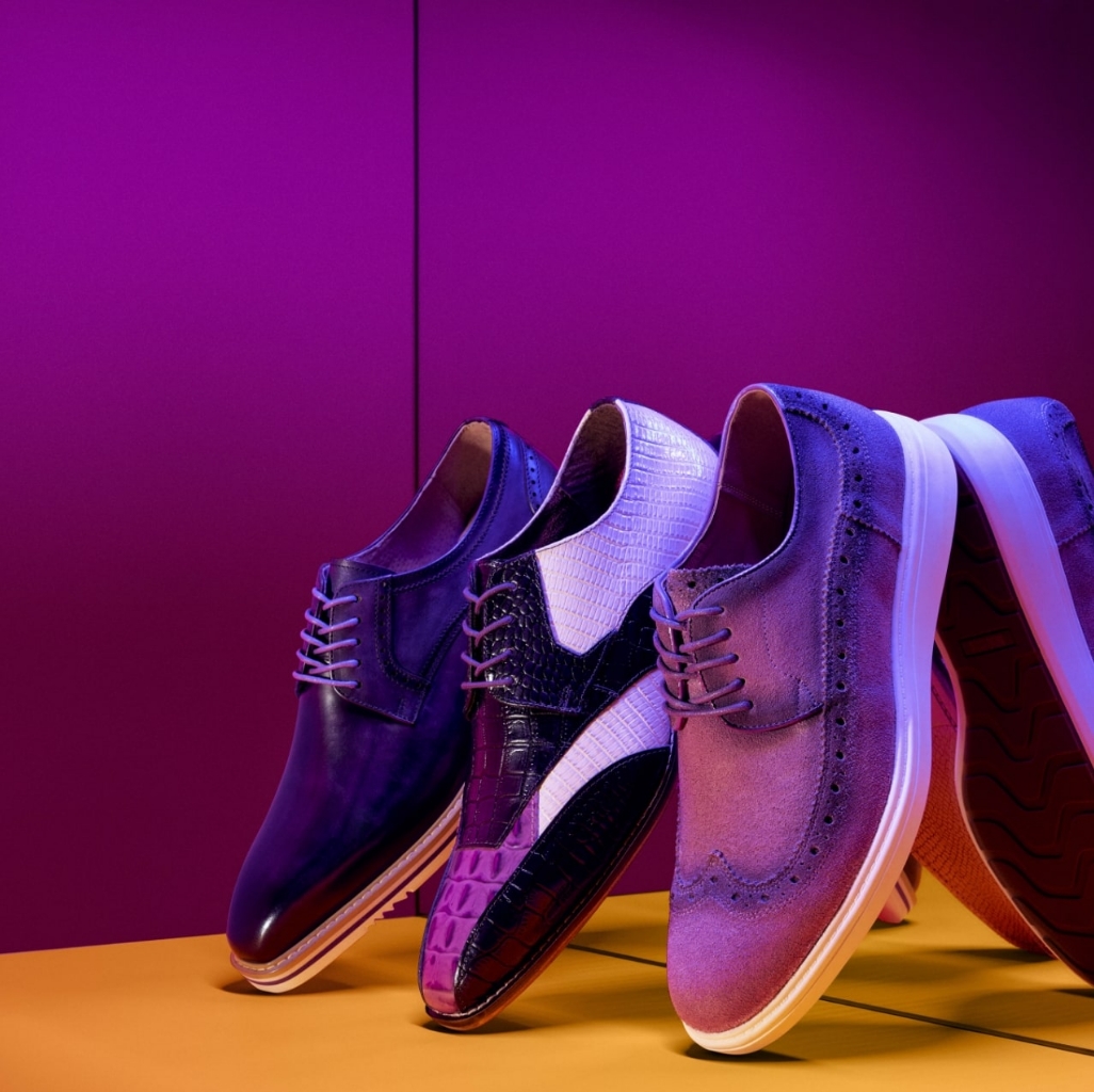 "Laces For Shoes: Step Up Your Style." The featured image is of three different Stacy Adams shoes in a purple hue on an orange background.