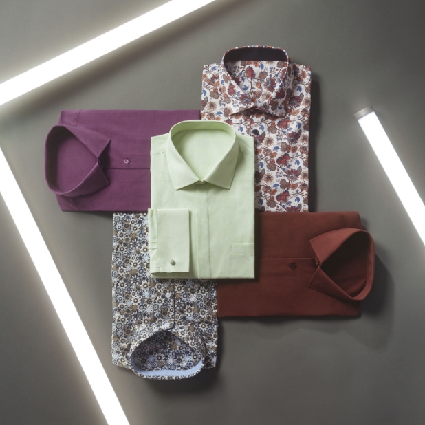 "Follow These Men's Style Tips For A Stylish Look From Head To Toe." The featured image is a stack of different colored dress shirts on a gray background.