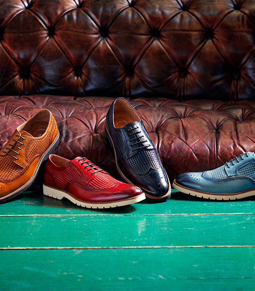 The featured image is a variety of wingtip dress shoe styles in cognac, red, navy, and blue.