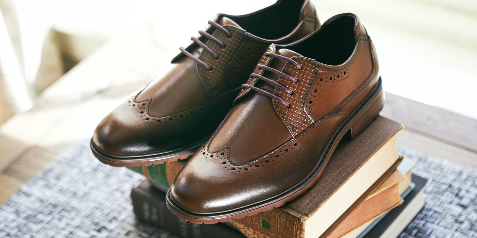 The featured product is the Rooney Wingtip Oxford in Cognac.