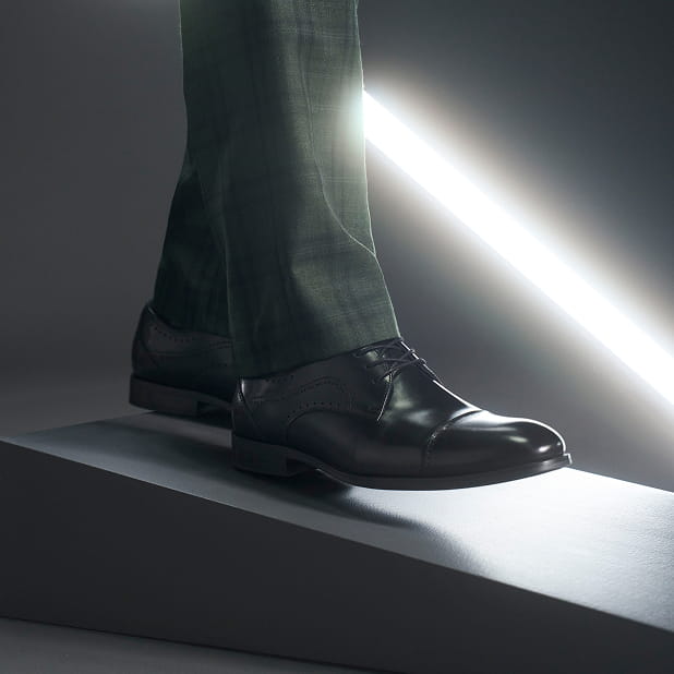 "First Date Or Weekly Ritual, Here Are Some Of Our Favorite Date Night Ideas And Shoes To Match." The featured image is a close-up of a Stacy Adams dress shoe in black with a bright light in the background.