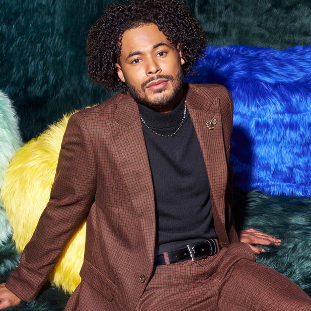 "Master The Differences Between A Blazer, Sport Coat, And Suit Jacket." The featured image is a model wear a dark green Stacy Adams suit jacket and collared shirt on a dark background.