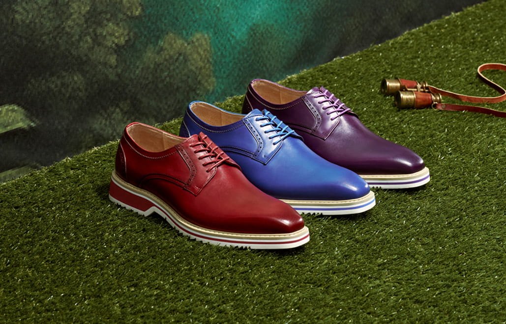"Keeping Up With Men’s Fashion Trends As The Seasons Change." The featured image shows three Oxford shoes in red, blue, and purple on a grass background.