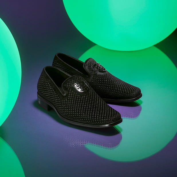 "Mini Me Fashion: Dressing Like Your Parent with Trendy Kids Shoes." The featured product is the Stacy Adams Swagger Studded Slip Ons in Black against a purple background with green glowing orbs.
