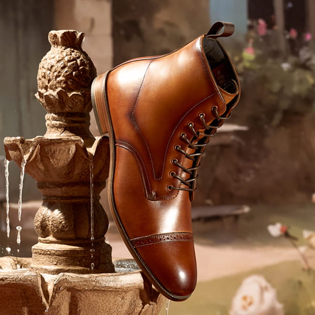 "Laces For Shoes: Step Up Your Style." The featured image shows a Stacy Adams Henry Cap Toe Lace Up Boot in Tan hanging off the side of a fountain.
