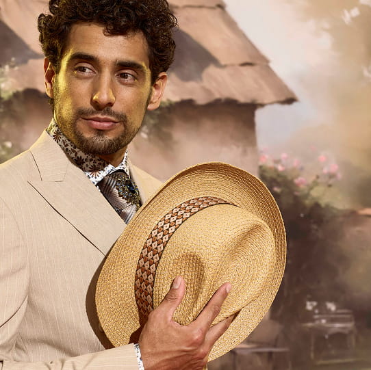 "Avoid Common Style Mistakes By Learning What Not To Wear." The featured image is a close up of a man wearing a formal suit, dress shirt, and tie and holding a hat.