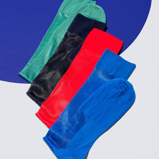 "Men’s Accessories that Complete your Look." The featured image shows four Stacy Adams socks in teal, black, red, and blue against a white and blue background.