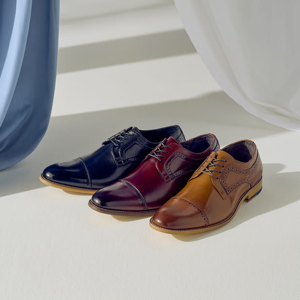 "In Search Of Versatile Men's Shoes? Our Dickinson Takes The Cake." The featured image shows three Stacy Adams Dickinson Cap Toe Oxfords in Black, Burgandy, and Cognac.