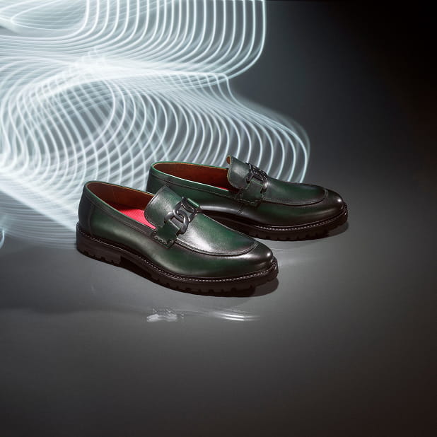 "What Is Business Casual? We're Here To Explain The New Rules." The featured image is of the Hale slip on loafer in green on a shiny, dark grey background with neon lights.