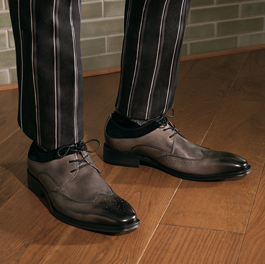 "These Are The Shoes Every Man Should Own." The featured product is the Hewlett Wingtip Oxford in Black/Gray.