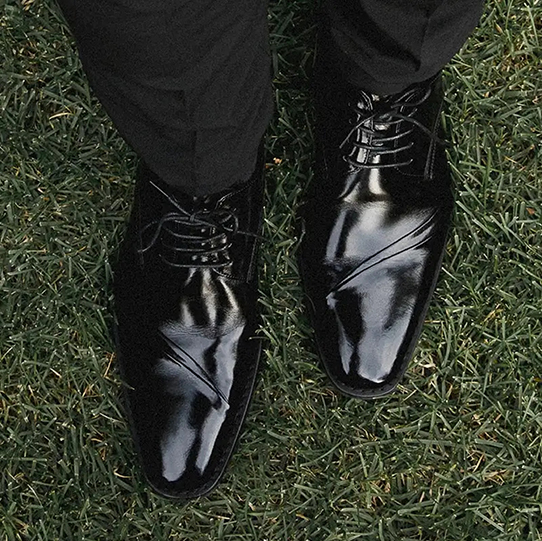 "When Wearing A Tuxedo, Make Sure Your Black Tie Attire Shines." The featured product is the Talmadge Folded Vamp Oxford in Black.