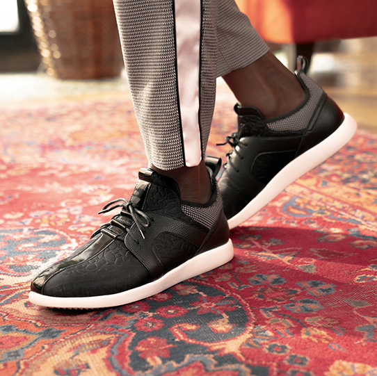 "In The World Of Men’s Casual Shoes, Sneakers Take Center Stage." The featured product is the Briscoe Center Seam Mid Lace in Black.