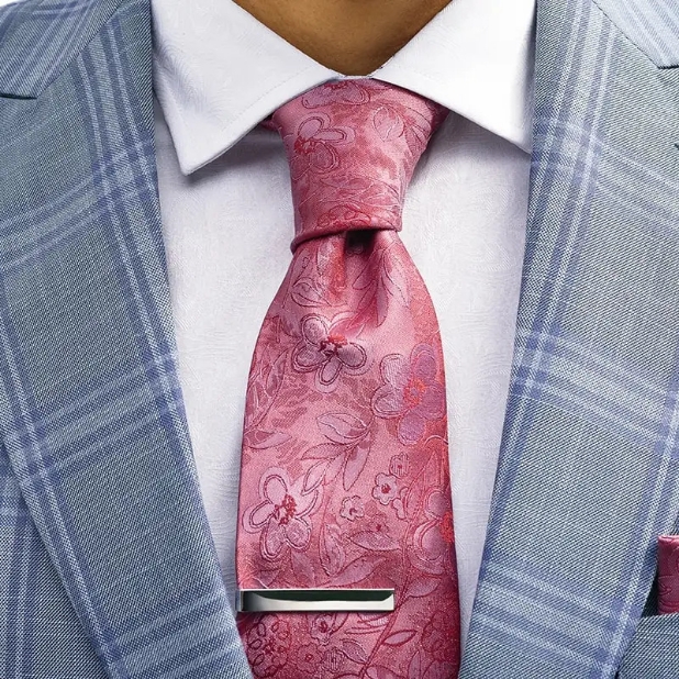 "Avoid Common Style Mistakes By Learning What Not To Wear." The featured image is a close up of a man wearing a formal suit, dress shirt, and tie.